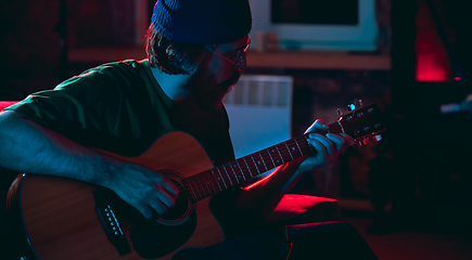 Image showing Close-up of musician performing in neon light. Concept of advertising, hobby, music, festival, entertainment.