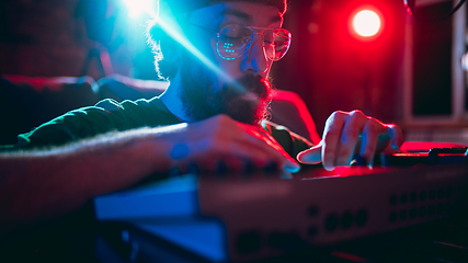 Image showing Close-up of musician performing in neon light. Concept of advertising, hobby, music, festival, entertainment.