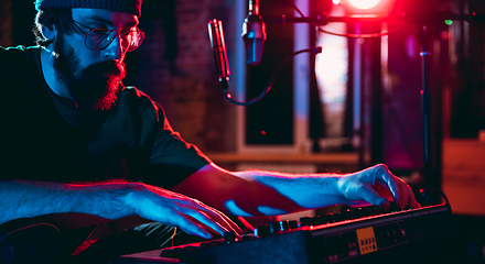 Image showing Close-up of musician performing in neon light. Concept of advertising, hobby, music, festival, entertainment.