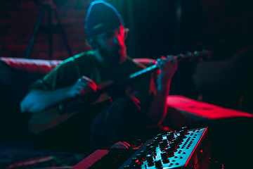 Image showing Close-up of musician performing in neon light. Concept of advertising, hobby, music, festival, entertainment.