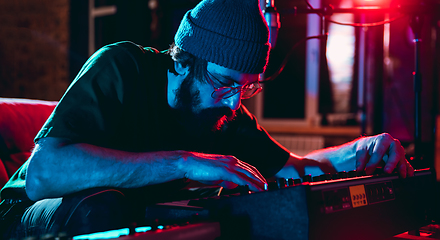 Image showing Close-up of musician performing in neon light. Concept of advertising, hobby, music, festival, entertainment.