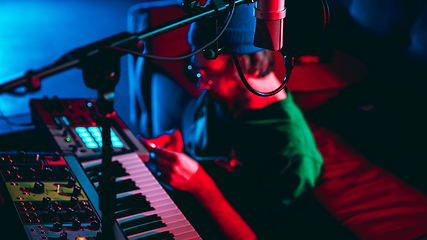 Image showing Close-up of musician performing in neon light. Concept of advertising, hobby, music, festival, entertainment.