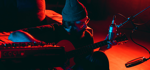 Image showing Close-up of musician performing in neon light. Concept of advertising, hobby, music, festival, entertainment.