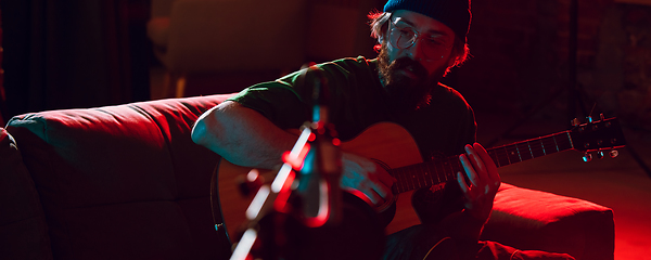 Image showing Close-up of musician performing in neon light. Concept of advertising, hobby, music, festival, entertainment.