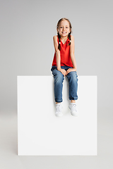 Image showing Happy kid, girl isolated on white studio background. Looks happy, cheerful, sincere. Copyspace. Childhood, education, emotions concept