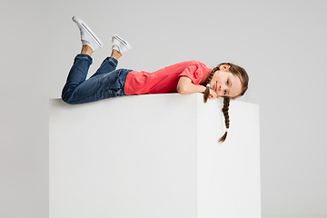 Image showing Happy kid, girl isolated on white studio background. Looks happy, cheerful, sincere. Copyspace. Childhood, education, emotions concept