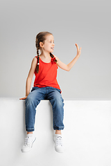 Image showing Happy kid, girl isolated on white studio background. Looks happy, cheerful, sincere. Copyspace. Childhood, education, emotions concept