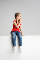 Image showing Happy kid, girl isolated on white studio background. Looks happy, cheerful, sincere. Copyspace. Childhood, education, emotions concept