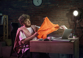 Image showing Young happy Caucasian man doing shopping online through laptop.