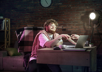 Image showing Young happy Caucasian man doing a manicure online through laptop.