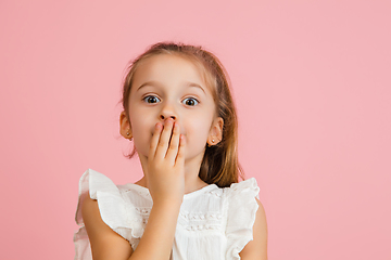 Image showing Pretty caucasian girl portrait isolated on pink studio background with copyspace