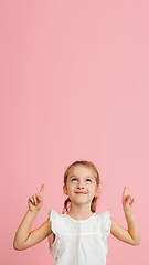 Image showing Pretty caucasian girl portrait isolated on pink studio background with copyspace