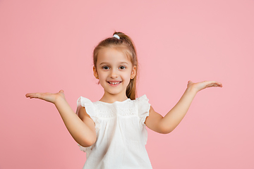 Image showing Pretty caucasian girl portrait isolated on pink studio background with copyspace