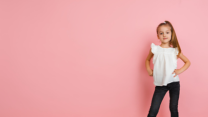 Image showing Pretty caucasian girl portrait isolated on pink studio background with copyspace