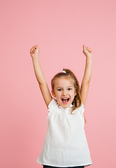 Image showing Pretty caucasian girl portrait isolated on pink studio background with copyspace