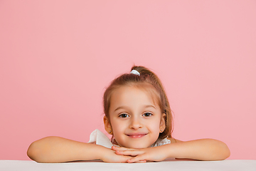 Image showing Pretty caucasian girl portrait isolated on pink studio background with copyspace