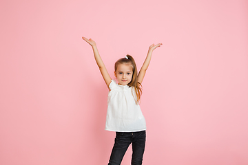 Image showing Pretty caucasian girl portrait isolated on pink studio background with copyspace