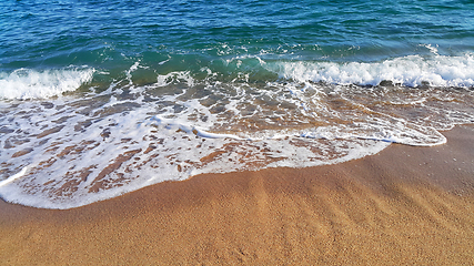 Image showing Sea wave with white foam in the coastal sand