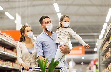 Image showing family with shopping cart in masks at supermarket