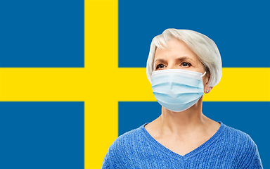 Image showing senior woman in mask over flag of sweden