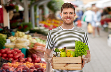 Image showing happy man with food in wooden box at street market