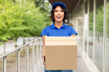Image showing happy delivery girl with parcel box in blue