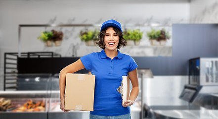 Image showing happy delivery girl with box and clipboard