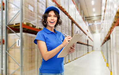 Image showing happy delivery girl with clipboard at warehouse