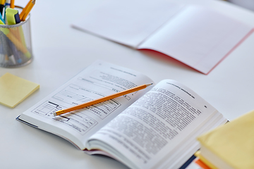 Image showing books, pencil and school supplies on table