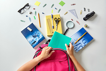 Image showing hands with backpack, books and school supplies