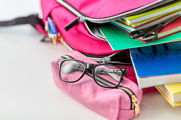 Image showing backpack, apple and school supplies on table