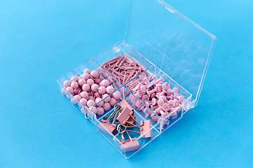 Image showing pins and clips in plastic pox on blue background