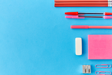 Image showing pink sticky notes, pens, pencils, clips and eraser