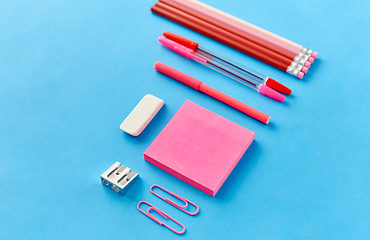 Image showing pink sticky notes, pens, pencils, clips and eraser