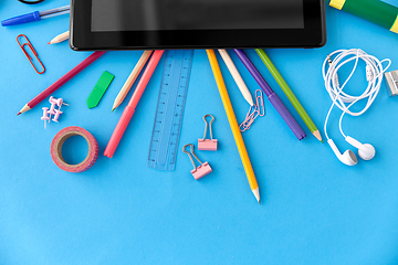 Image showing tablet pc and school supplies on blue background