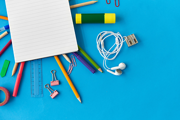 Image showing notebook and school supplies on blue background