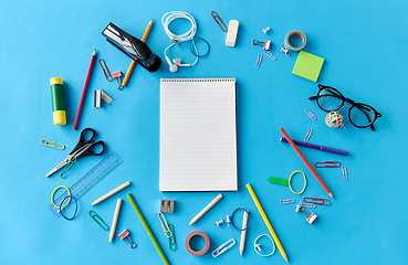 Image showing notebook and school supplies on blue background