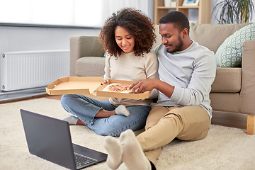 Image showing happy african american couple eating pizza at home