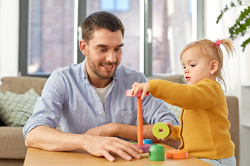 Image showing father playing with little baby daughter at home