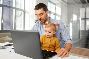 Image showing working father with baby daughter at home office