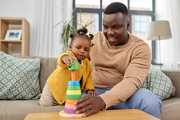 Image showing african family playing with baby daughter at home