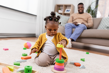 Image showing african baby girl playing with toy blocks at home