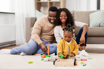 Image showing african family playing with baby daughter at home