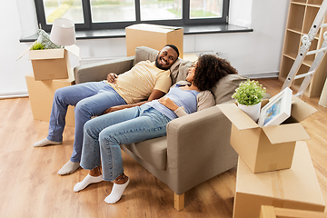 Image showing happy couple with boxes moving to new home