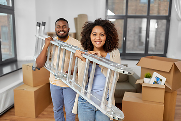 Image showing happy couple with ladder moving to new home
