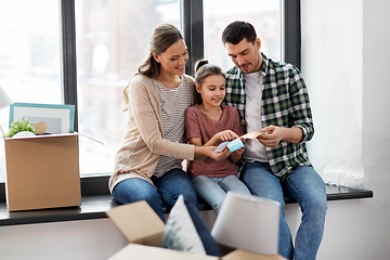 Image showing happy family with color palette moving to new home