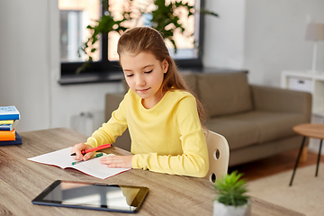 Image showing student girl writing to notebook at home