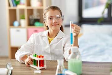 Image showing girl with test tube studying chemistry at home