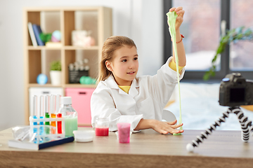 Image showing girl with slime and camera video blogging at home