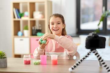 Image showing girl with slime and camera video blogging at home